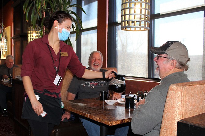 Bodine’s server Alondra Enriquez serves coffee to regulars Gary Werner (far right) from Carson City and brother Mike Werner from Dayton. (Photo: Ronni Hannaman)