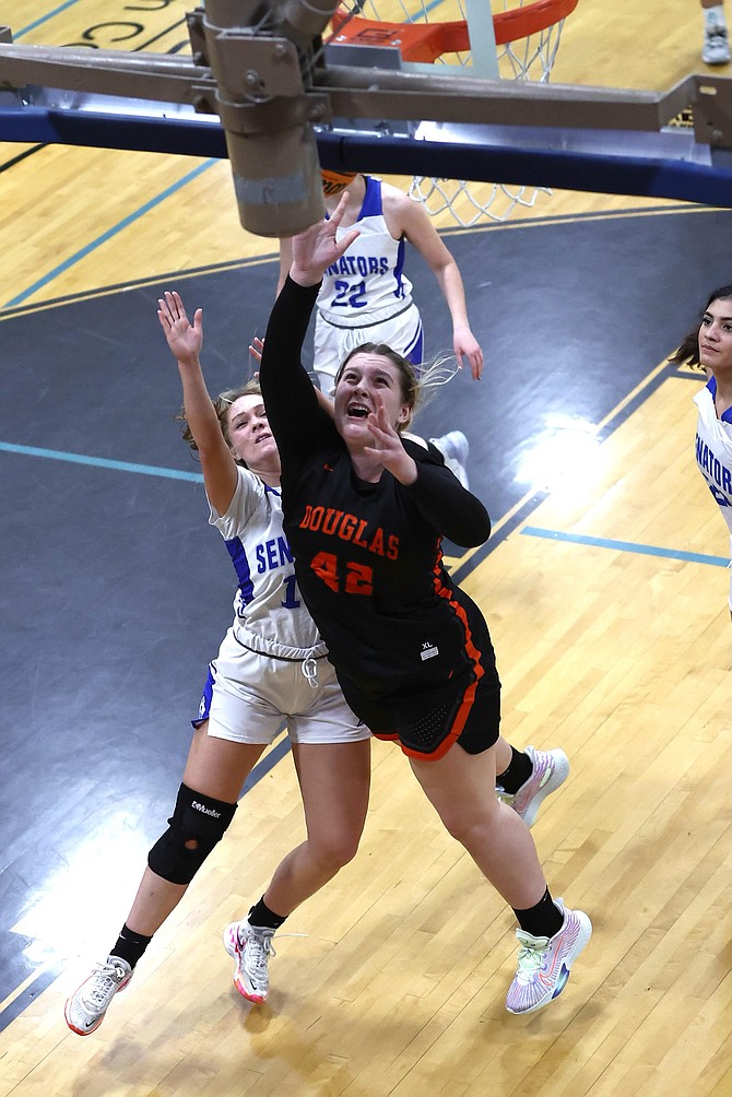 Douglas High's Riley Mello (42) goes up for a layup against Carson High School Tuesday night in the Tigers'