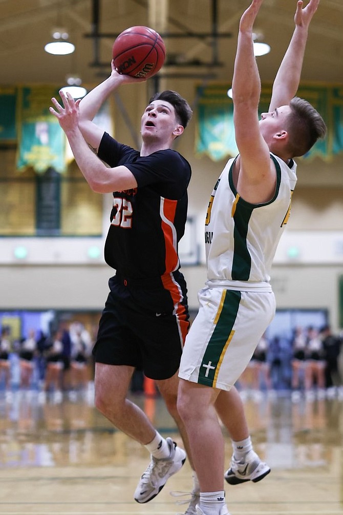 Douglas High's Chris Myers (32) goes up for two of his six points in the Tigers' regional semifinal win over Bishop Manogue Wednesday night. The Tigers punched their ticket to the Class 5A state tournament with the win.