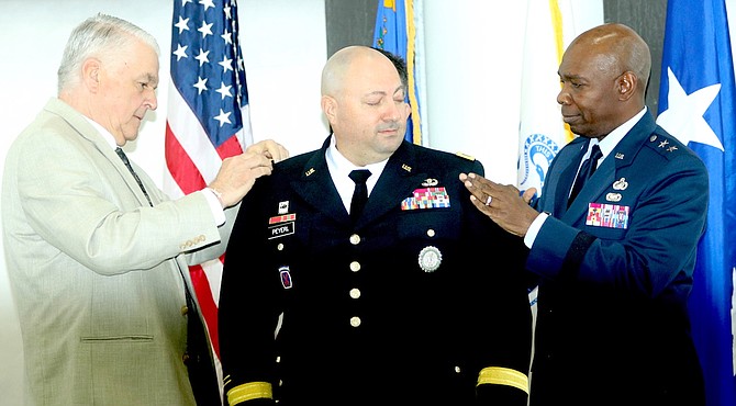 Gov. Steve Sisolak, left, and Maj. Gen. Ondra Berry, the adjutant general of the Nevada National Guard, promote Michael Peyerl to the rank of brigadier general in a Friday ceremony.