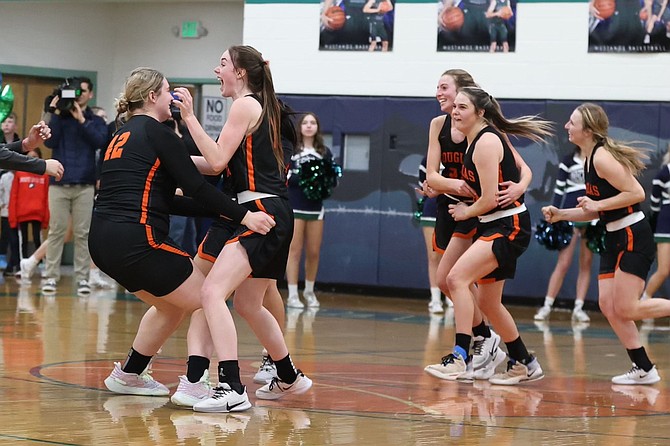 The Douglas High girls basketball team storms the floor in celebration of winning its regional semifinal game against Damonte Ranch, clinching a spot in the Class 5A state tournament.