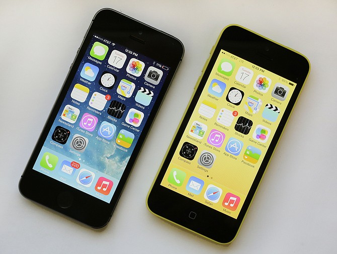 The iPhone 5S, left, and iPhone 5c are displayed in 2013. (AP Photo/Mark Lennihan)