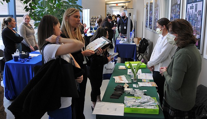 Carson Nursing and Rehabilitation Center visits with Western Nevada College second-year nursing students, from left, Shantell Copsy, Justine Sanders-Colgan and Misty Ota at WNC’s Job Fair on Feb. 15 in the Cedar Building.