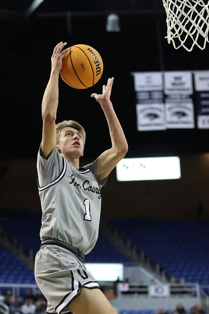 Douglas High senior Kasen Boggs goes up for a layup during the Class 5A state semifinals against Liberty High Friday evening at Lawlor Events Center. Boggs had 13 points in his final game in a Tiger uniform.