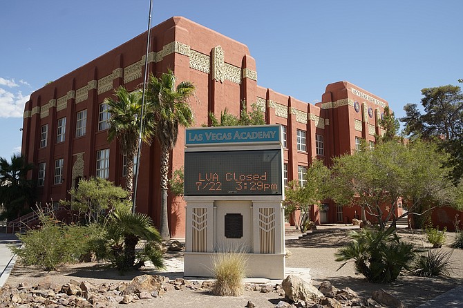 FILE - A sign announces that the Las Vegas Academy is closed on July 22, 2020, in Las Vegas. (AP Photo/John Locher)