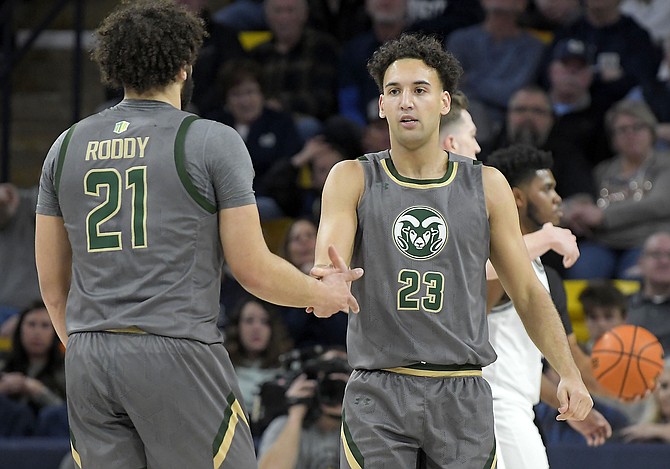 Colorado State guard Isaiah Rivera (23) is congratulated by guard David Roddy after being fouled against Utah State on Feb. 26, 2022, in Logan, Utah. (Eli Lucero/The Herald Journal via AP)