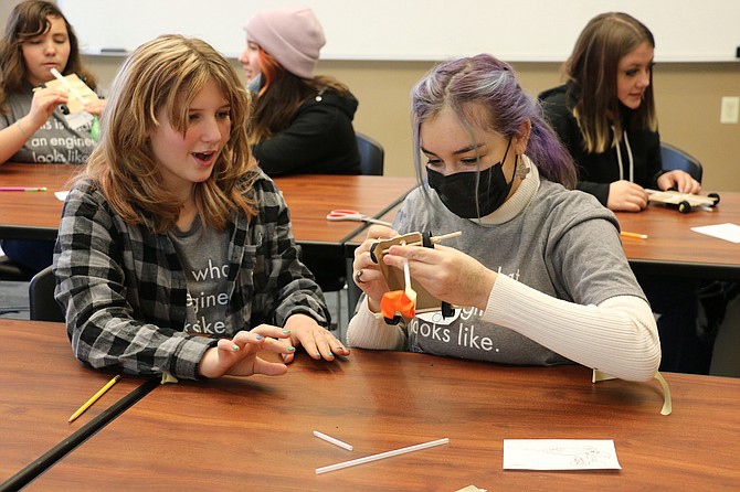 Elizabeth Nolan, left, and Emery Giurlani, seventh graders of Carson Middle School, build a car as part of an activity during 'Introduce a Girl to Engineering' Day at the University of Nevada, Reno on Thursday.  (Photo: Jessica Garcia/Nevada Appeal)