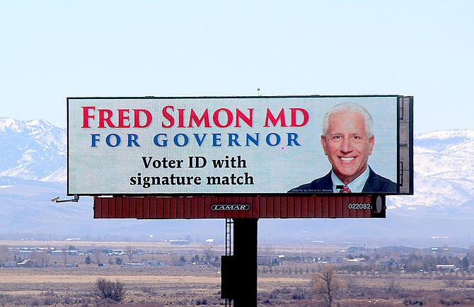 Foothill resident Dr. Fred Simon's visage greets motorists entering Carson Valley from a billboard.