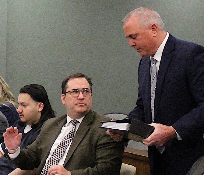 Douglas County District Attorney Mark Jackson confers with defense attorney John Arrascada, as Wilber Martinez-Guzman sits during his sentencing in Douglas County court on March 3, 2022.