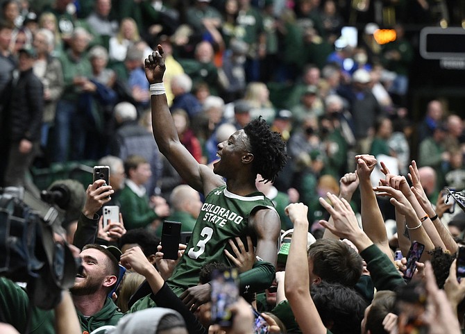 Colorado State guard Kendle Moore (3), hoisted on the shoulders of fans, celebrates the win against Boise State on March 5, 2022, in Fort Collins, Colo. (Photo: Andy Cross/The Denver Post via AP)