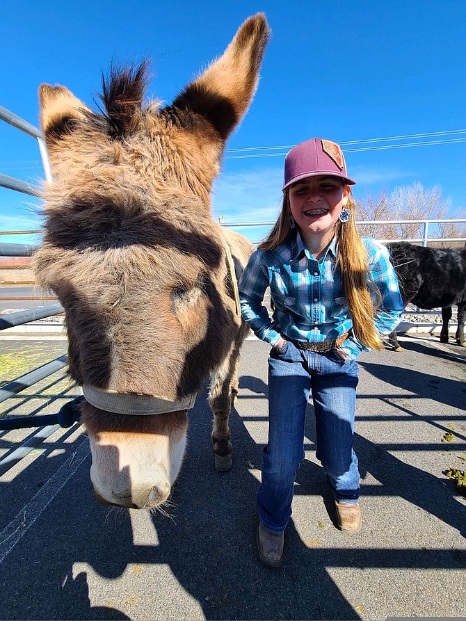 Addison Allegre poses with here donkey.