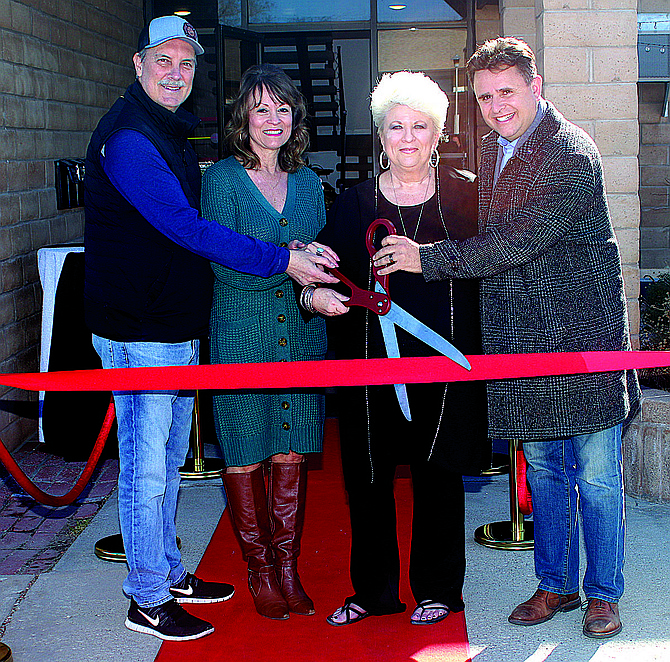 Mayor Ken Tedford, left, along with Just in Time Tux Studio’s Lee Quint and Kathleen Hanley, and Sparks Councilman Kristopher Dahir, a friend of the owners, participate in a ribbon cutting.