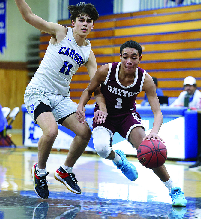 Dayton High’s Isaiah Powell dribbles around Carson’s Brandon Graunke during an early season contest between Dayton and Carson. Powell was named as a second team all-league selection in Northern Class 3A.