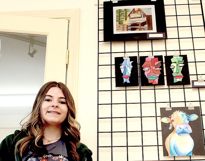 Douglas High School artist Gwen Scossa poses with her painting, at top, which is one of 40 pieces of student art on display at the Copeland Gallery in Minden through March 30. Douglas High art teacher Kelly Yost’s students’ work may be viewed 10 a.m. to 5 p.m. Monday through Saturday.