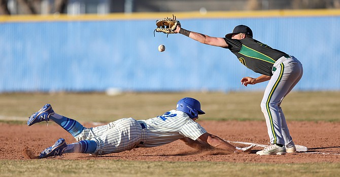 Carson High's Ian Fontaine (22) dives back into the base during Carson High's 4-3 loss to Bishop Manogue Tuesday. Fontaine was 1-for-2 for the Senators.