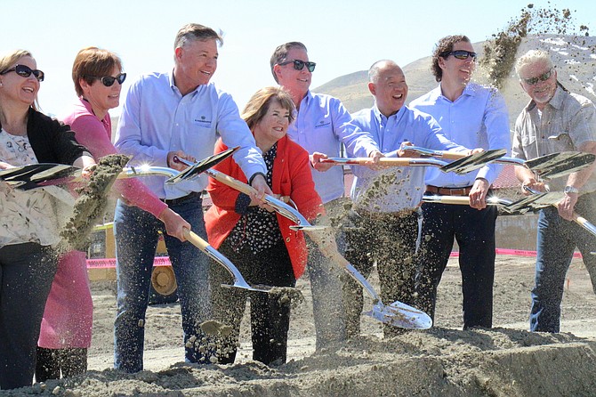 Mayor Lori Bagwell (center) breaks ground on a new 140-unit apartment complex with city staff and Kingsbarn Capital & Development executives.