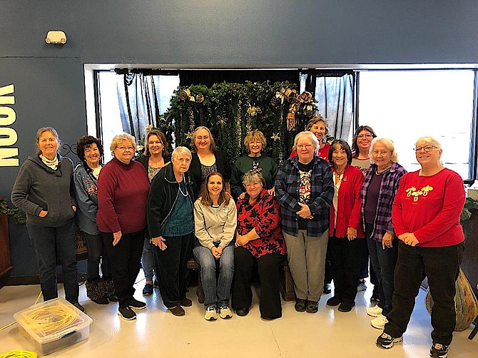 The Hearts of Gold quilters pose for a photo during the holidays.