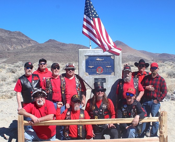 Members from the Julia Bulette 1864 chapter and its outpost Copper Queen 1915 of E Clampus Vitus pose in front of a memorial erected and re-dedicated in honor of five Navy crew members who died in a helicopter crash on March 22, 1978.