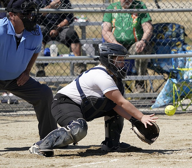 Oasis Academy’s Kaitlyn Hert blocks a pitch in the dirt in Friday’s game against Pyramid Lake.