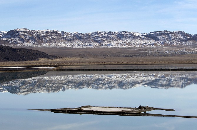 Mountains are reflected in an evaporation pond at the Silver Peak lithium mine in Esmeralda County on Jan. 30, 2017.