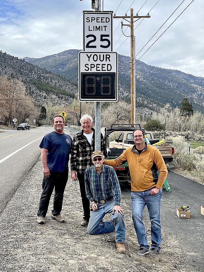 Gordon Pasley, Brendan Riley, Bill Brooks and Town Manager Matt Bruback installed a new traffic radar sign south of Genoa on March 30. Photo special to The R-C