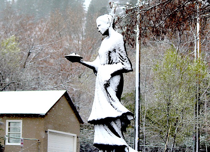 Blizzard conditions in Genoa plastered the statue of Lillian Virgin Finnegan with snow on Monday.