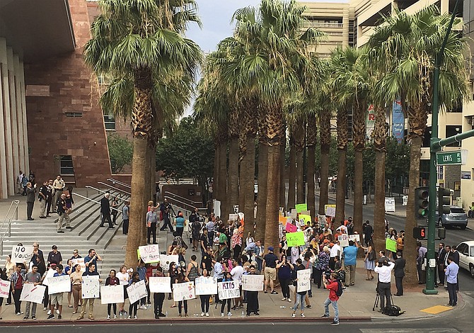 Protesters for and against a school choice program voice their opinions about the measure being argued before the Nevada Supreme Court in Las Vegas on July 29, 2016.