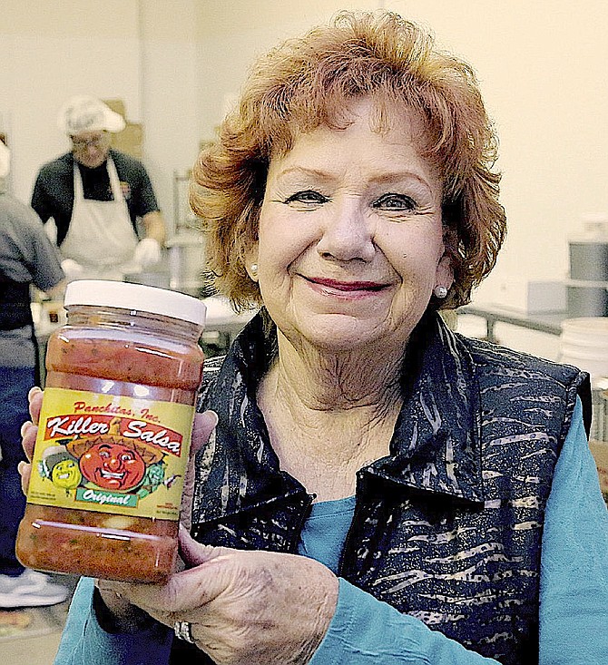 Fran Pritchard in 2018 with a jar of her Killer Salsa. Jim Grant | R-C File Photo