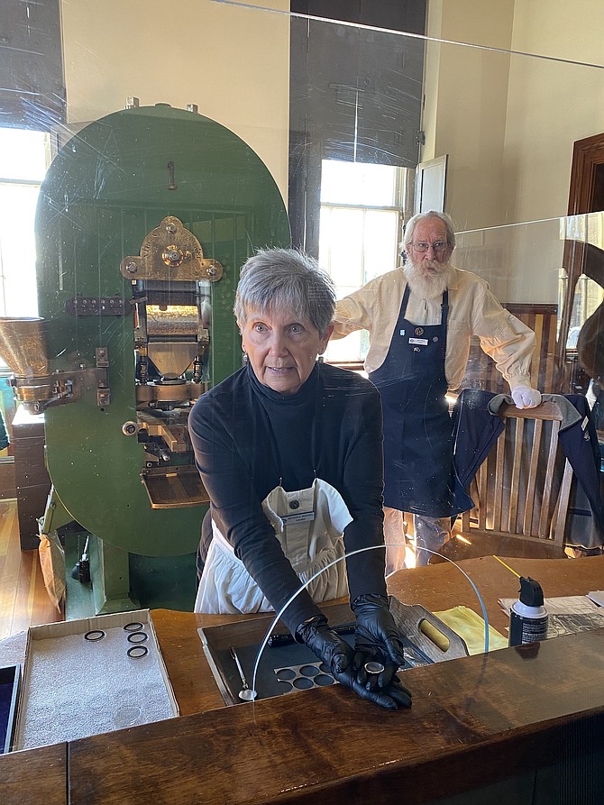 Volunteers Beverly Wickel (front) and Jim Spain introduce the Carson City Mint to museum visitors.
