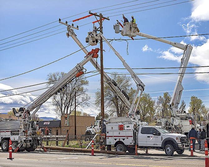 Four NV Energy boom trucks were involved with replacing a pole in the Gardnerville S Curve around lunchtime on Thursday.