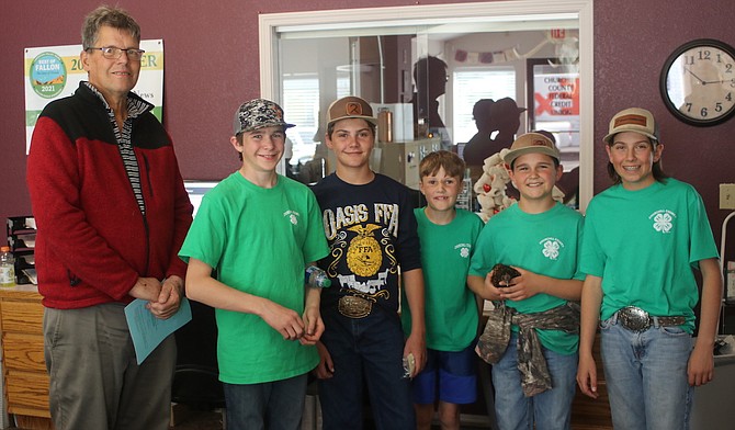 FFA and 4-H students recently “Walked the Town” to solicit support for the annual Churchill County Junior Livestock Show and Sale, which begins Thursday. The students stopped in a Churchill County Federal Credit Union and dropped off literature on the show. From left are the credit union’s CEO Gary Cordes, Jackson Barbee, Rio Segura, Ryder Segura, Cody Frey and Riggin Stonebarger.