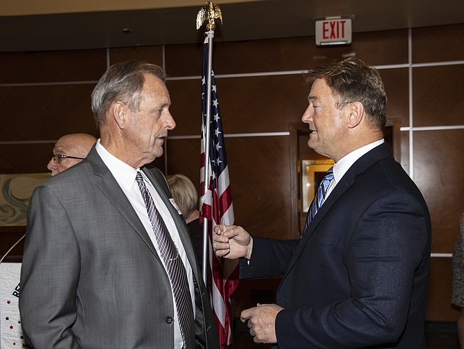 Nevada Republican gubernatorial candidates North Las Vegas Mayor John Lee, left, and former U.S. Sen. Dean Heller chat before a luncheon forum hosted by the Republican Women of Las Vegas group on April 20, 2022, in Las Vegas.
