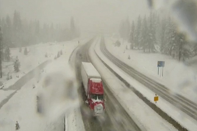 In this image taken from video from a Caltrans remote video traffic camera, a truck makes its way past the snow along Interstate 80 near Highway 267 in Truckee on April 21, 2022.