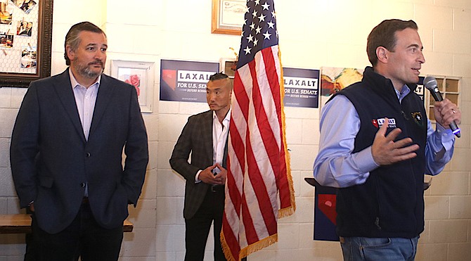 Adam Laxalt, a candidate for U.S. Senate, talks to supporters at a rally April 21, 2022 with Texas Sen. Ted Cruz behind him.