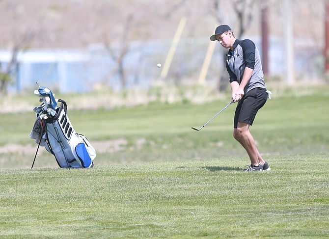 Senator senior Lukas Taggart chips on to the green during a home meet at Eagle Valley Golf Course on Monday. Taggart led Carson with a 73, taking third as an individual.