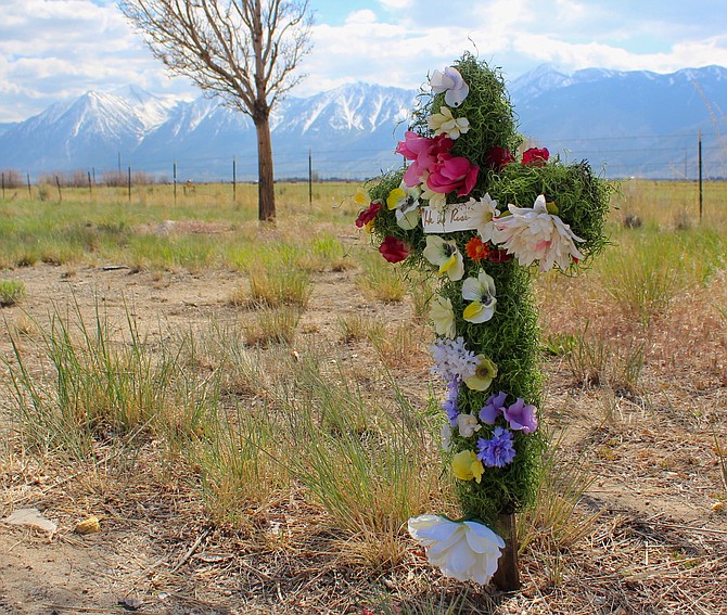 A memorial sits at the site of a fatal collision along Highway 395 just north of Airport Road