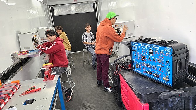 Oasis Academy and Churchill County High School students are learning about automated manufacturing, robotics, machining, blueprint reading and manufacturing technology as part of WNC’s Automation and Industrial Technology program this spring. Students pictured are working in WNC’s Express Tech mobile lab.