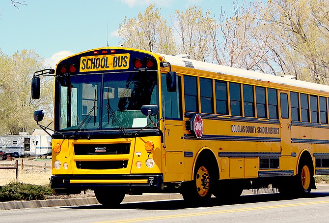 A Douglas County school bus makes its rounds on Buckeye Road on Thursday afternoon.