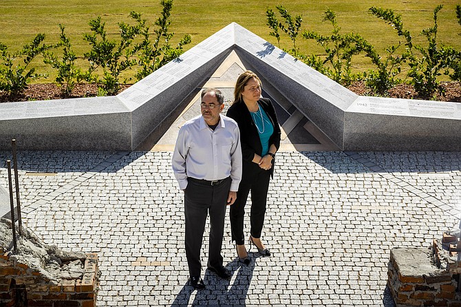 Jay Poster, left, founder and general manager of King David Memorial Chapel and Cemetery, and Celena DiLullo, president of Palm Mortuaries, pose for a photo at the Holocaust Memorial Plaza at King David Memorial Chapel and Cemetery in Las Vegas on April 21, 2022.