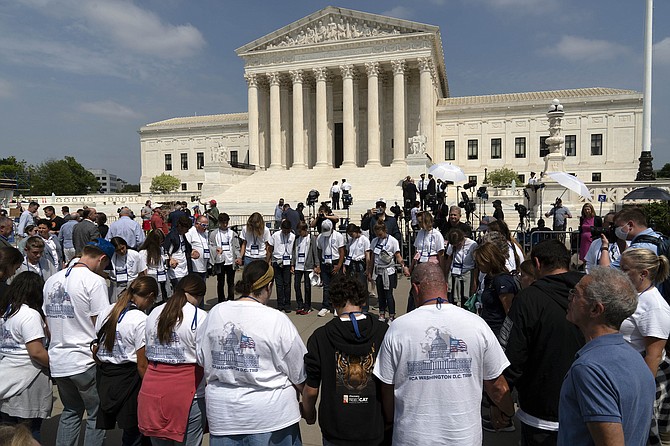 People pray outside of the U.S. Supreme Court on May 3, 2022 in Washington.
