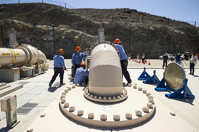 Southern Nevada Water Authority maintenance mechanics install a spacer flange after removing an energy dissipator at the Low Lake Level Pumping Station (L3P3) at Lake Mead National Recreation Area on April 27, 2022, outside of Las Vegas.