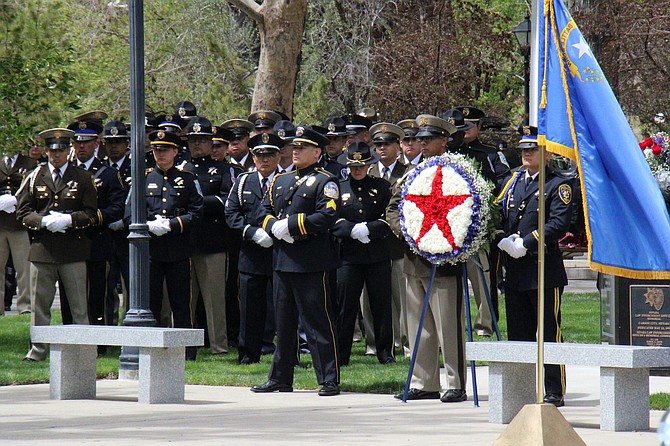 Law enforcement officers place a wreath on Capitol grounds, honoring fallen officers.