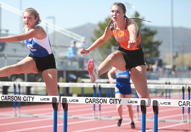 Douglas High’s Logan Karwoski clears a hurdle during the McQueen meet, hosted by Carson High. Karwoski took fourth in the 100-meter hurdles in 19.71.