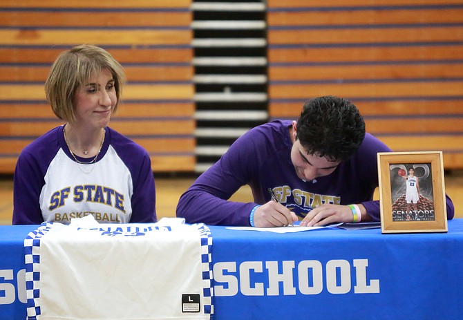 Carson High’s Parsa Hadjighasemi, alongside his mother, Ashley, signs his National Letter of Intent to play basketball at San Francisco State. Hadjighasemi set numerous school and state records while playing for the Senators.