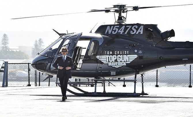 Tom Cruise walks to the red carpet after riding a helicopter to the world premiere of "Top Gun: Maverick" on May 4  at the USS Midway in San Diego.