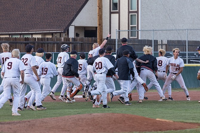 The Douglas High boys baseball team celebrates after Gabe Natividad's walk-off hit in the 12th inning against Spanish Springs in the Class 5A regional consolation round.