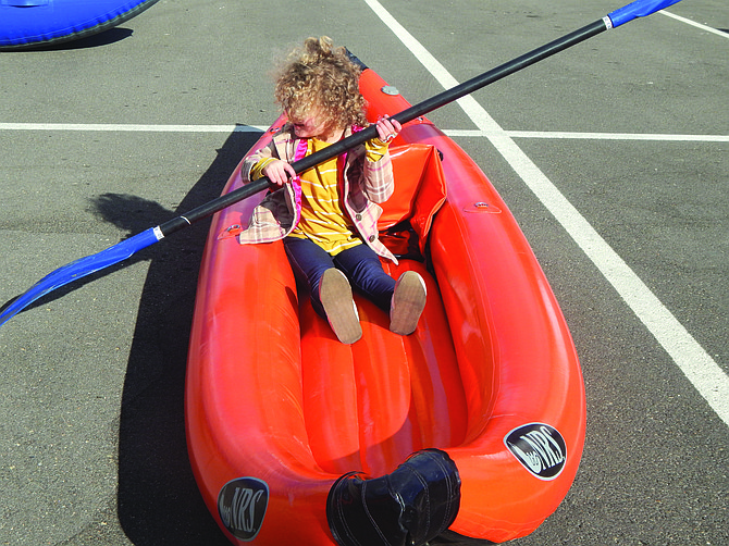 Three-year-old Amelia Horning tries out the Douglas County Search and Rescue canoe during the Sheriff’s Office Open House Wednesday.