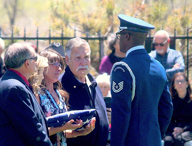 A member of a U.S. Air Force Honor Guard presents the flag from Fallon Montanucci's coffin to her parents at Eastside Memorial Park in Minden in May 2022.