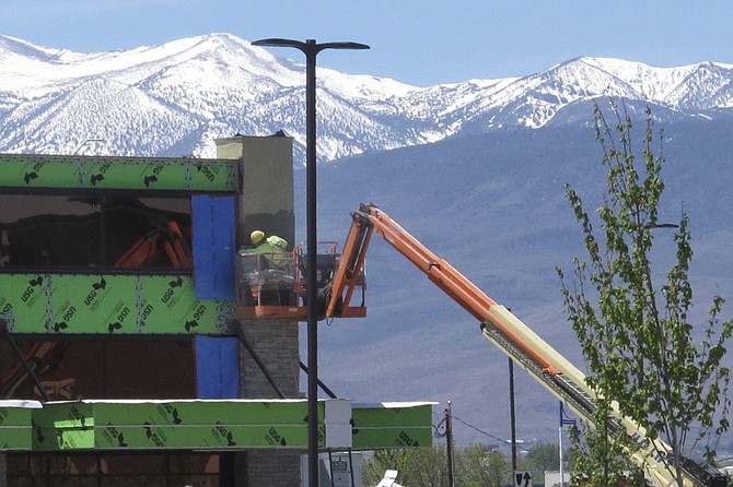 A construction worker works on the exterior of Legends Bay Casino in Sparks on May 13, 2022.