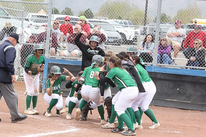Fallon junior Lydia Bergman is mobbed at home plate after hitting a home run against Elko in the 3A North regional tournament in Winnemucca.
